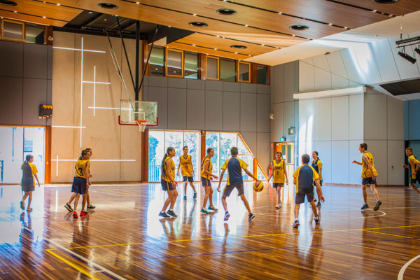Students playing basketball in Clancy Catholic College school hall