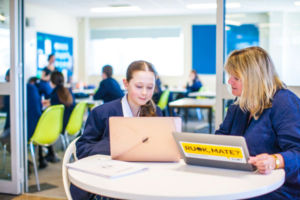 Teacher working with student outside modern classroom at Clancy Catholic College West Hoxton