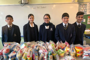 Year 7 and Year 8 students at Clancy Catholic College West Hoxton packing snack packs for Vinnies