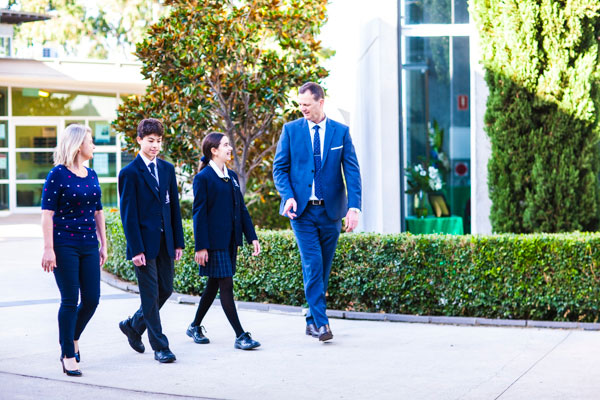 Principal and Assistant Principal of Clancy Catholic College West Hoxton walking with students