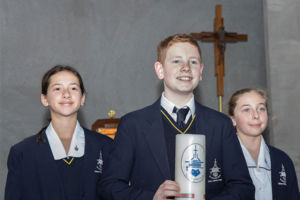 Three Clancy Catholic College West Hoxton students carrying school candles in school chapel