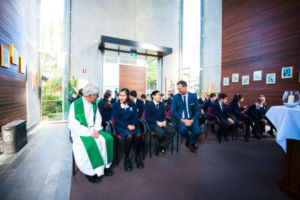 Parish priest and principal of Clancy Catholic College West Hoxton sitting and chatting with students in school chapel