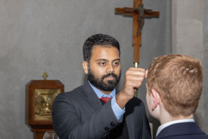 Student at Clancy Catholic College West Hoxton receiving blessing from staff in school chapel