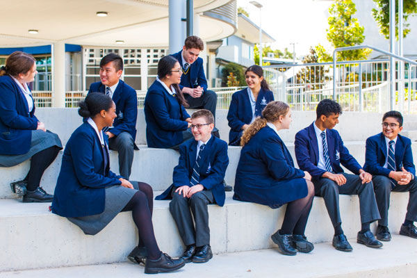 Students at Clancy Catholic College sitting and chatting on steps